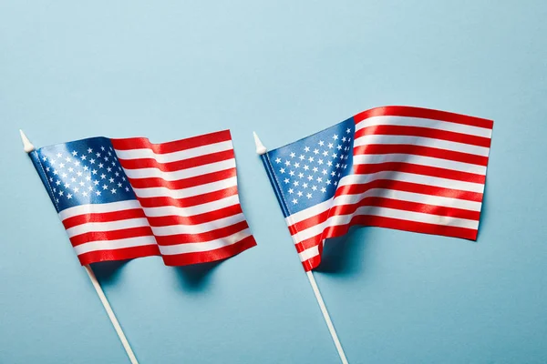 Top view of american flags on blue background — Stock Photo