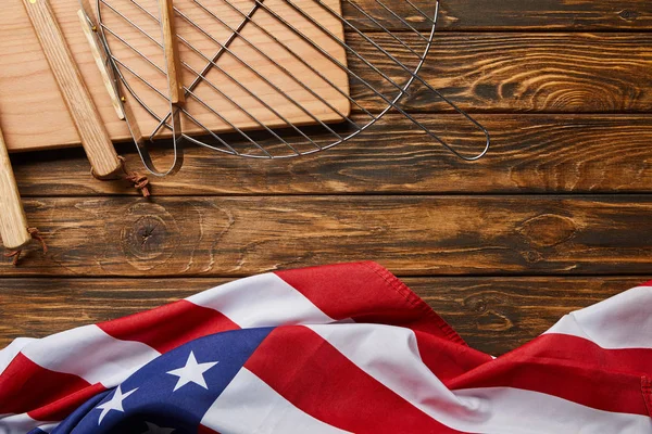 Top view of american flag and bbq equipment on wooden rustic table with copy space — Stock Photo