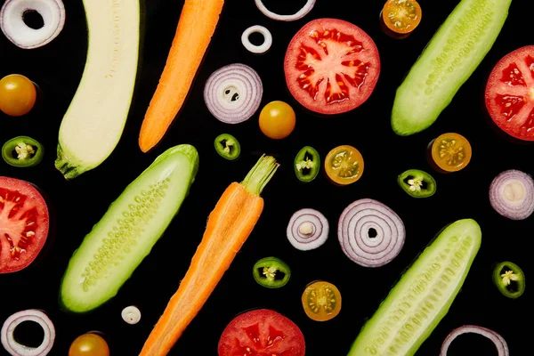 Top view of fresh ripe sliced vegetables isolated on black — Stock Photo