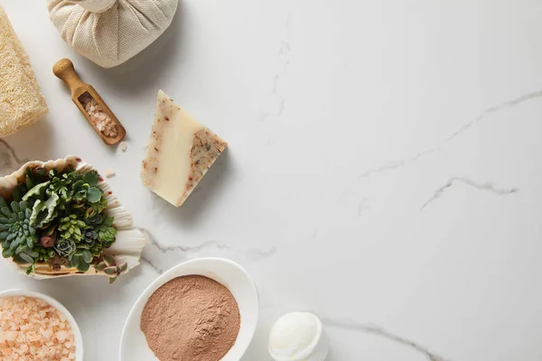 Top view of organic cosmetics on marble table with green succulent — Stock Photo