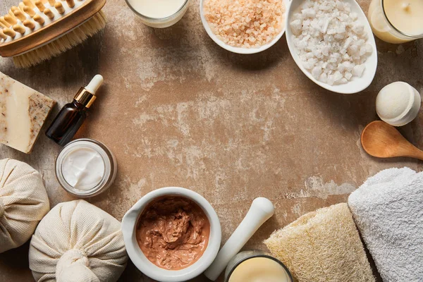 Top view of natural cosmetic ingredients on textured weathered beige surface — Stock Photo