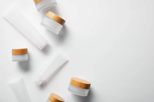 Top view of different jars and moisturizers on white — Stock Photo