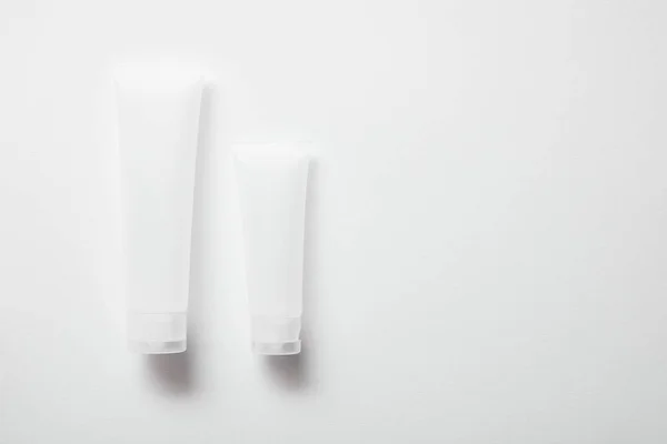 Empty cream tubes for hand cream on white — Stock Photo