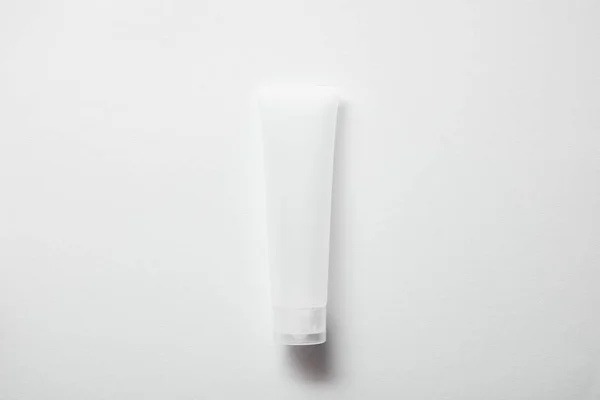 Top view of empty plastic cream tube on white — Stock Photo