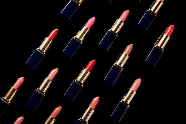 Flat lay with various shades of lipsticks isolated on black — Stock Photo