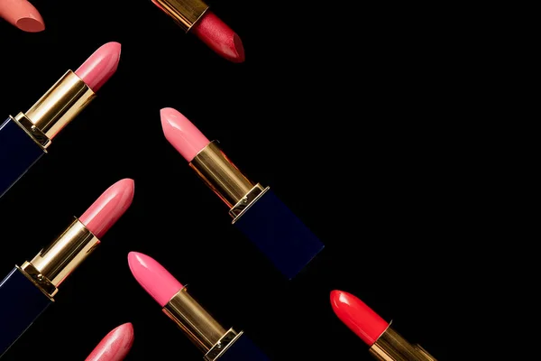 Flat lay with various shades of lipsticks isolated on black with copy space — Stock Photo