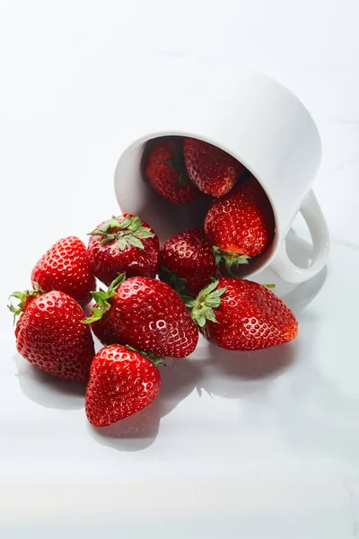 Köstliche rote Erdbeeren in Tasse auf weißem Hintergrund — Stockfoto