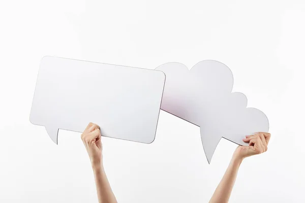 Cropped view of woman with thought and speech bubbles in hands, isolated on white — Stock Photo
