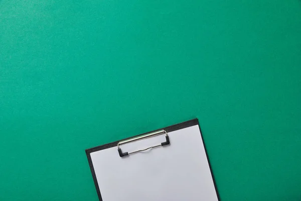 Folder with blank paper isolated on green — Stock Photo