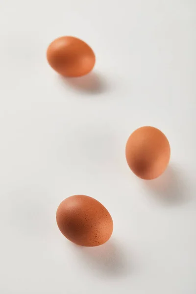 Selective focus of chicken eggs on white surface — Stock Photo