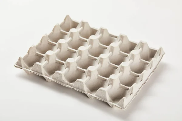 Empty egg carton box on white surface — Stock Photo