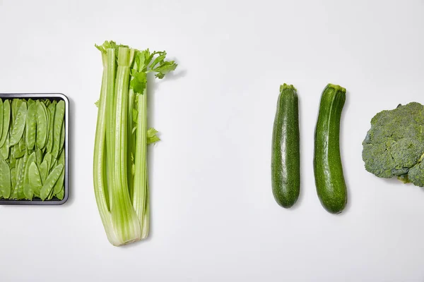 Top view of green fresh vegetables on white background — Stock Photo