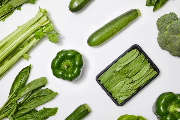 Top view of green nutritious vegetables on white background — Stock Photo