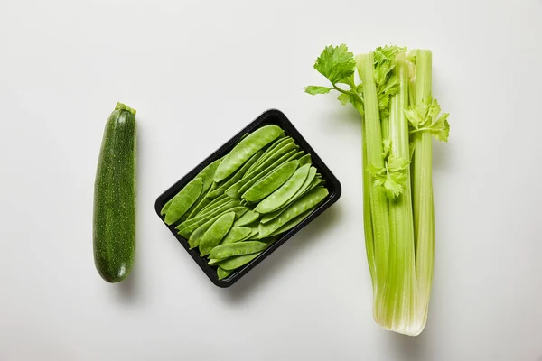 Top view of green organic vegetables on white background — Stock Photo
