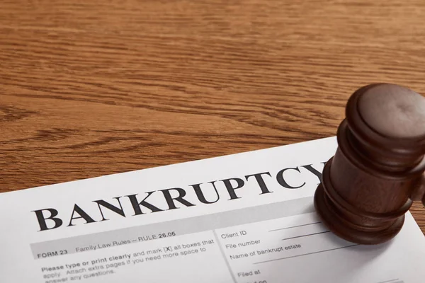 Bankruptcy form with wooden gavel on brown wooden table — Stock Photo