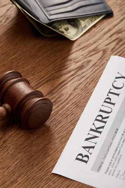 Bankruptcy form with wooden gavel, dollar banknote in wallet on brown wooden table — Stock Photo