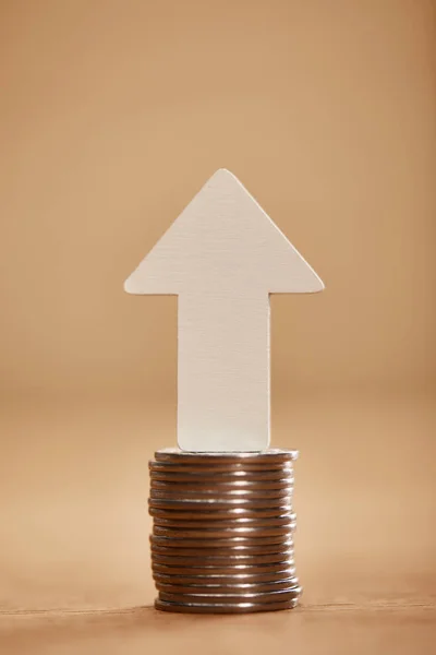 Stack of coins with white arrow upwards, financial growth concept — Stock Photo