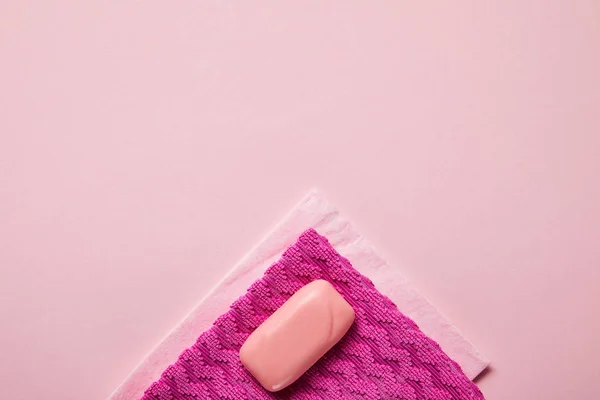 Top view of pink rags and soap on pink background — Stock Photo