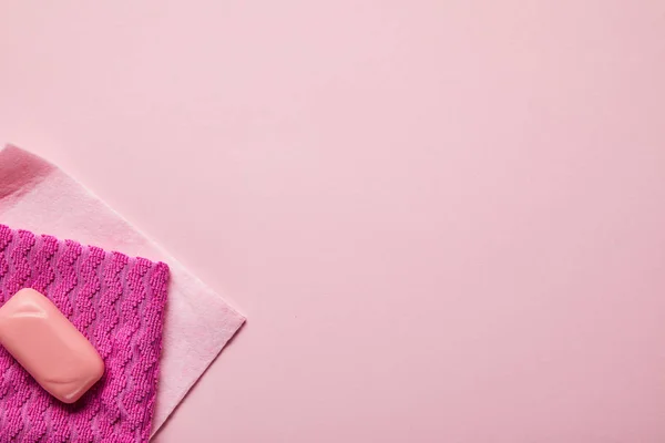 Top view of pink rags and soap on pink background — Stock Photo