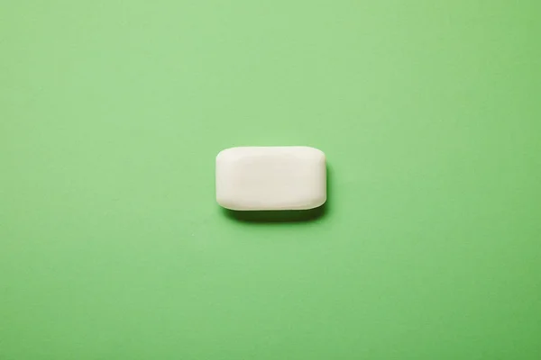 Top view of white soap on green background with copy space — Stock Photo