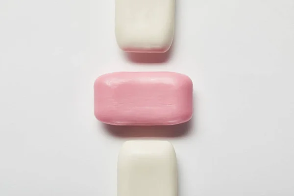 Top view of pink and white soaps on grey background — Stock Photo