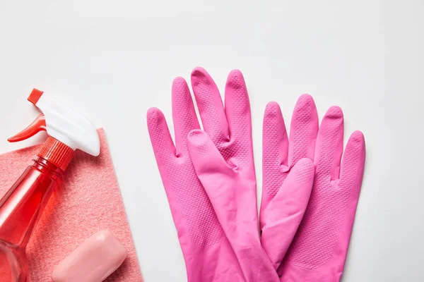 Vista dall'alto di stracci rosa e sapone, guanti di gomma e spray — Foto stock