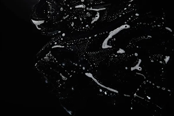 Верхний вид белого мыла на черном фоне с копировальным пространством — стоковое фото