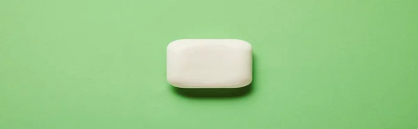 Panoramic shot of white soap on green background with copy space — Stock Photo