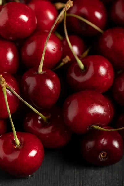 Close up view of red delicious shiny cherries on wooden table — Stock Photo