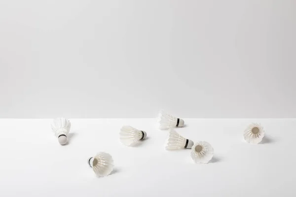 White badminton shuttlecocks scattered on white background — Stock Photo