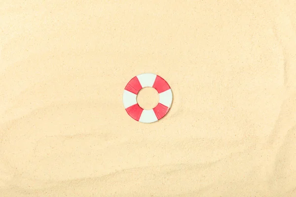 Top view of paper beach with lifebuoy on textured sand — Stock Photo