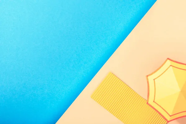 Top view of paper blue sea with towel and umbrella on shore — Stock Photo