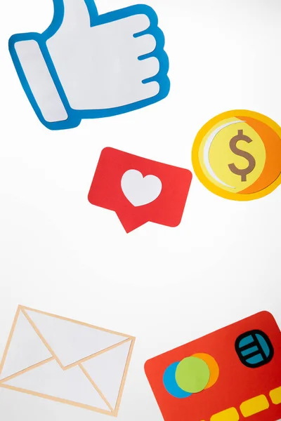 Colorful paper icons with envelope, coin, credit card, hearts and thumb up on white background — Stock Photo