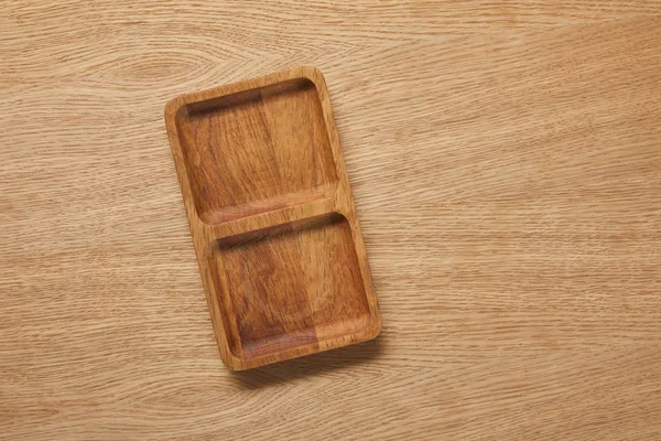 Vue de dessus de la plaque vide en bois sur la table en bois — Photo de stock