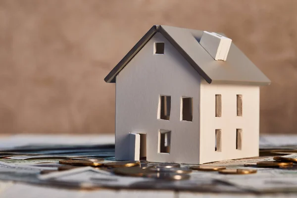 House model on dollar banknotes and coins, real estate concept — Stock Photo