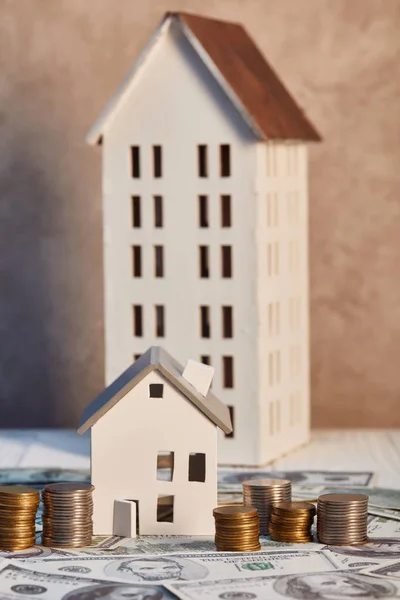 Maisons modèles sur table en bois blanc près de l'argent, concept immobilier — Photo de stock