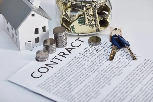 House model on white table with contract, keys and silver coins, real estate concept — Stock Photo