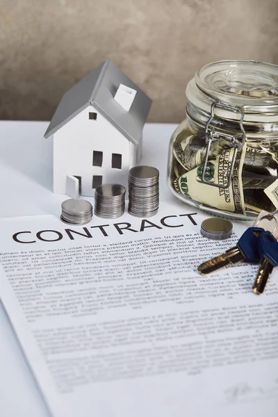 House model on white table with contract, keys, moneybox and silver coins, real estate concept — Stock Photo