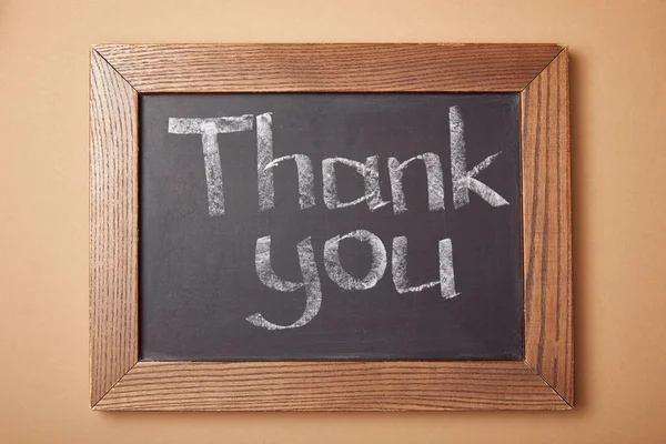 Chalkboard with thank you lettering on beige background — Stock Photo