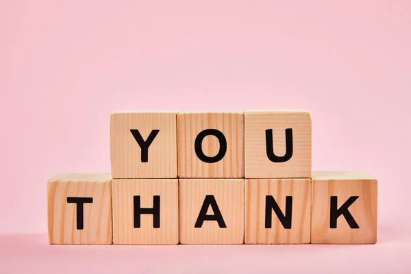 Holzblöcke mit Dankesworten auf rosa Hintergrund mit Kopierraum — Stockfoto