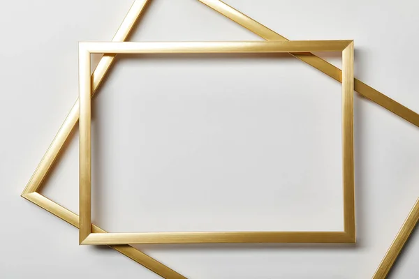 Top view of empty golden frames on white background with copy space — Stock Photo