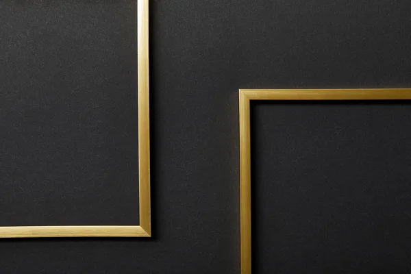 Top view of empty golden frames on black background with copy space — Stock Photo