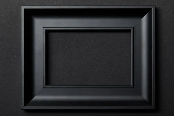 Top view of empty black frame on black background with copy space — Stock Photo