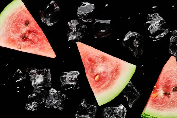Top view of red watermelon slices with melting ice isolated on black — Stock Photo