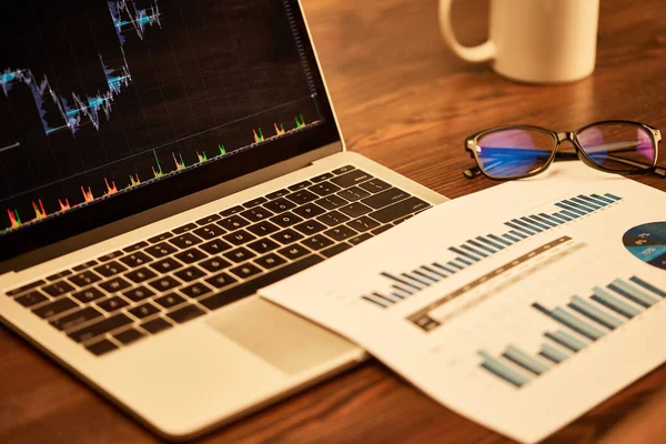 Selective focus of glasses, paper and laptop on table — Stock Photo