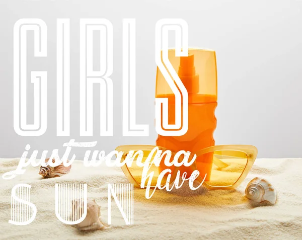 Yellow stylish sunglasses and sunscreen in orange bottle on sand with seashells on grey background with girls just wanna have sun illustration — Stock Photo