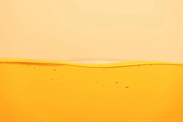 Yellow bright liquid with underwater bubbles isolated on yellow — Stock Photo