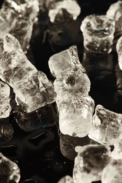 Transparent cool ice cubes on black background — Stock Photo