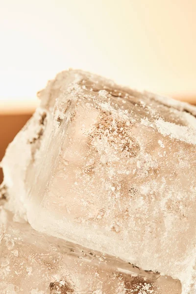 Stack of textured frosted ice cubes on illuminated background — Stock Photo