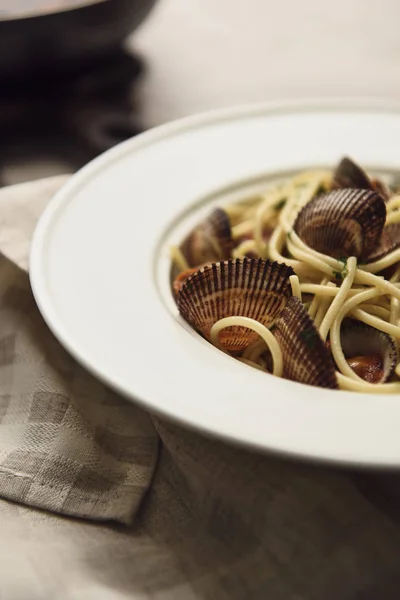 Close up view of delicious pasta with mollusks on napkin — Stock Photo
